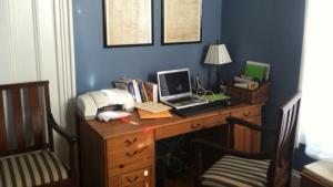 a blogger's desk with laptop and lamp on it