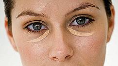 a woman with a concealer under her eyes