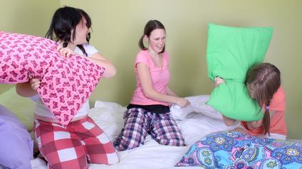 a pillow fight among three girls