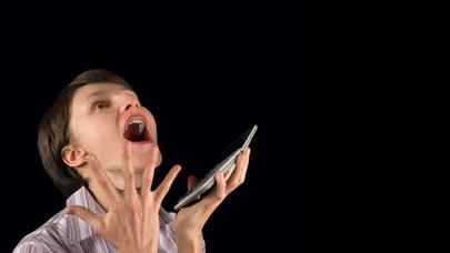 a woman screaming with a cell phone in her hands