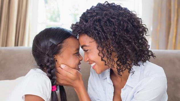 gifts a mother can give to her daughter: Happy african american mother and daughter looking into each others eyes