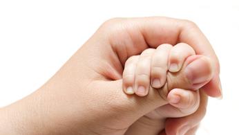 a baby holding a daughter's hand