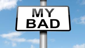 a sign post inscribed with words 'my bad'