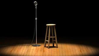 A stool and a mic under spotlight