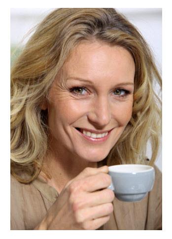 DM Mature Woman Having Coffee and Smiling.jpg
