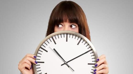 a woman holding a wall clock