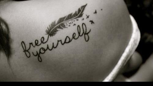 a tattoo saying 'free yourself'