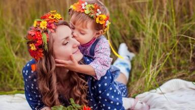 a daughter kissing her mother