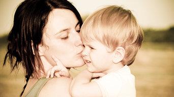 a woman kissing a baby
