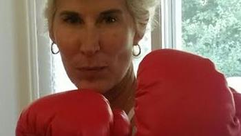 Picture of a woman wearing boxing gloves