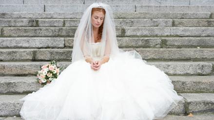 a bride sitting on steps alone