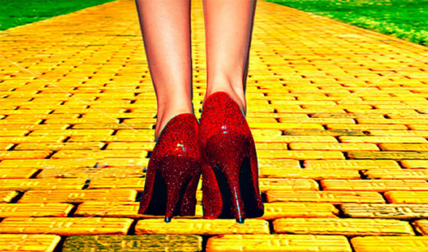 red glittery shoes walking on a yellow brick road