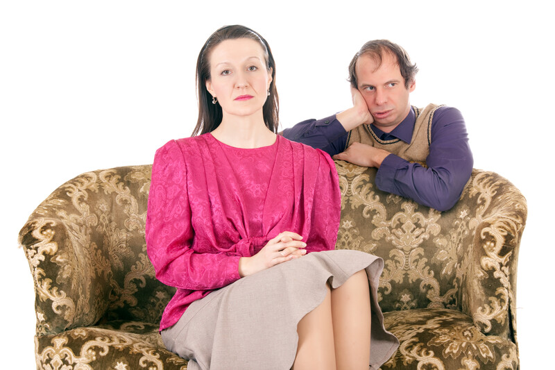 estranged couple sitting on a couch