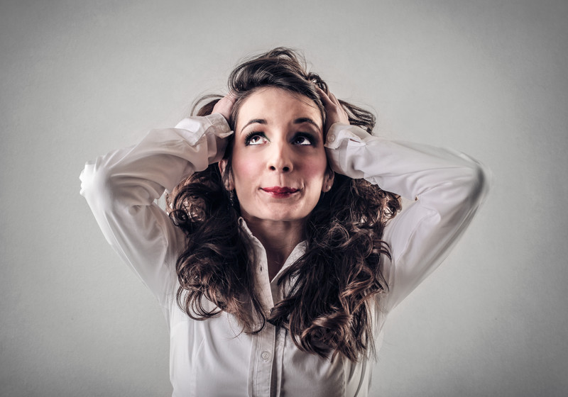 anxious woman with hands on top of head