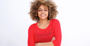 courageous black woman in red sweater with arms crossed