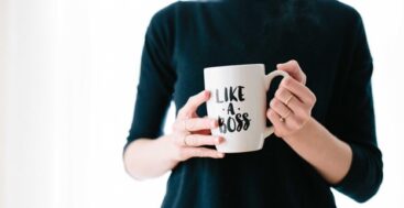 empowered woman holding a mug that says boss babe