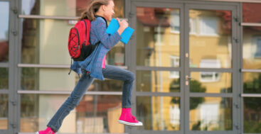 school child running with backpack