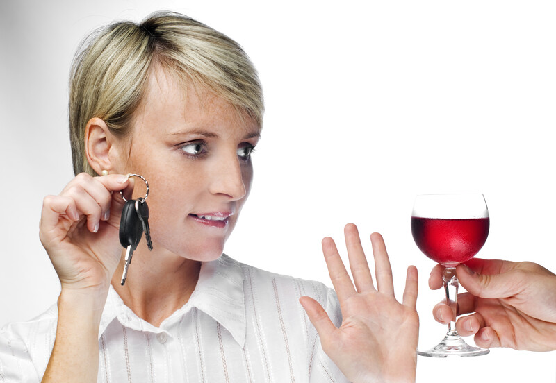 woman holding car keys and saying no to a drink